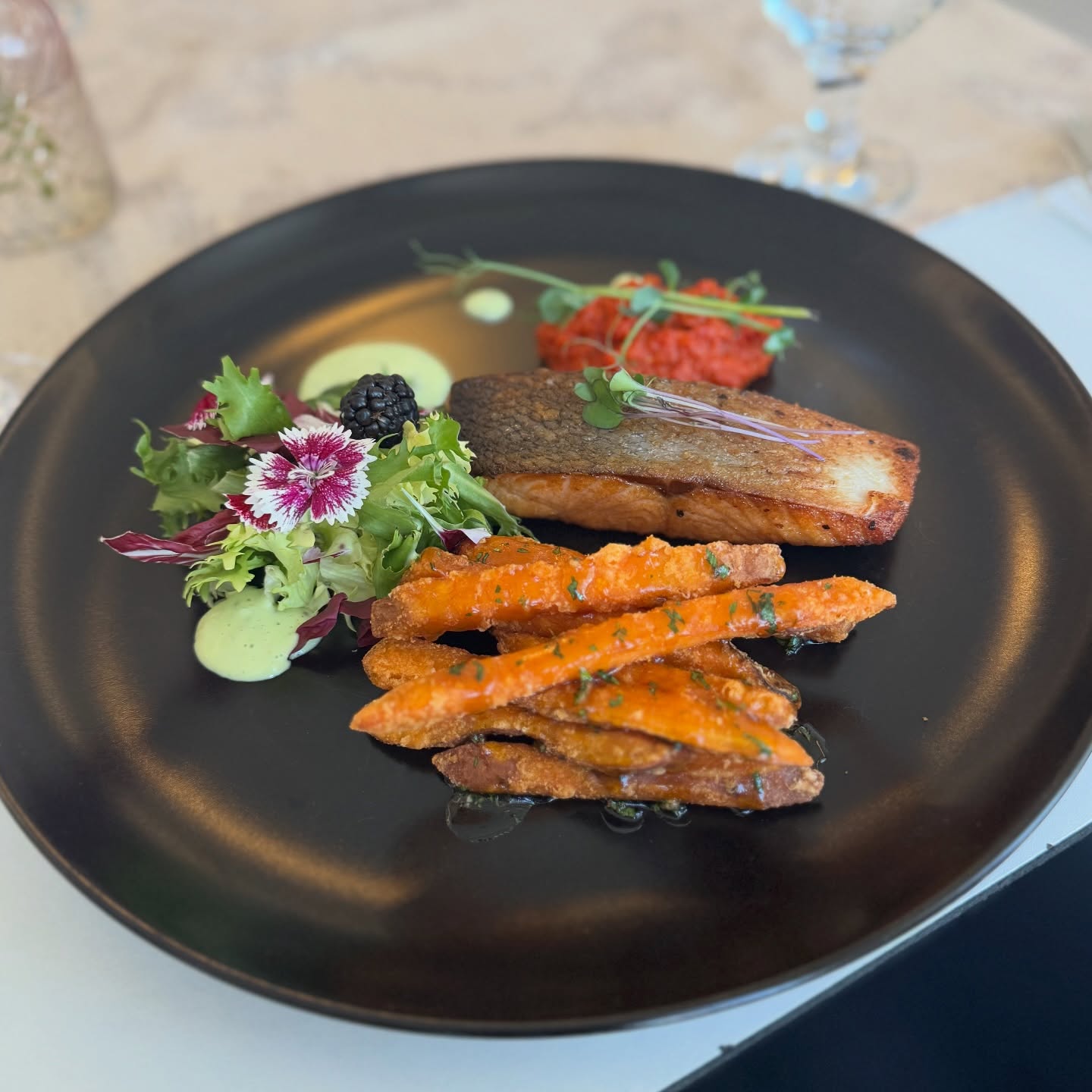 Łosoś z frytkami z batata i sałatą w restauracji Aleksandria